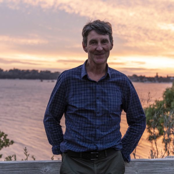 Image of Brendan Edgar standing at a lookout over the Swan River, WA at sunset.