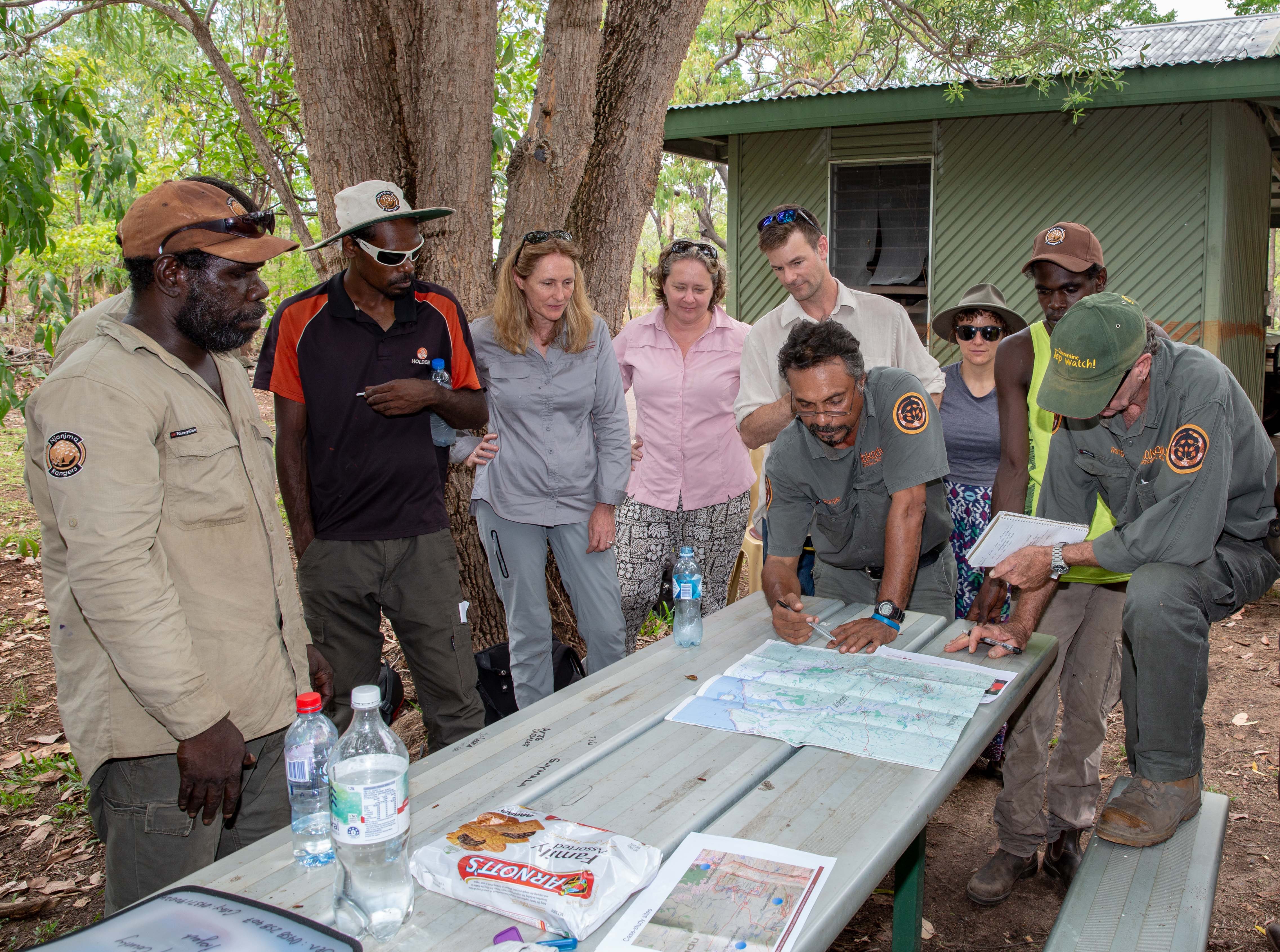 Bininj/Mungguy Research Steering Committee, Kakadu staff and Researchers assess maps at table