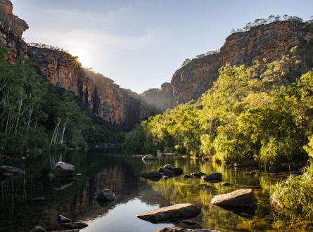Sunburst above the escarpment with shade and still water below