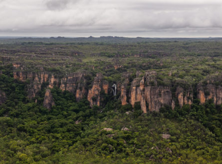 Kakadu escarpment with small waterfall under grey wet season skies