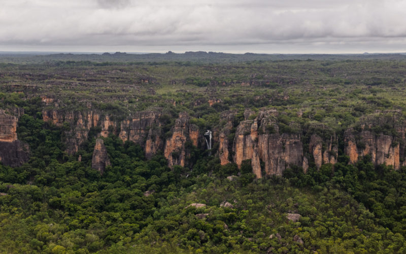 Kakadu escarpment with small waterfall under grey wet season skies
