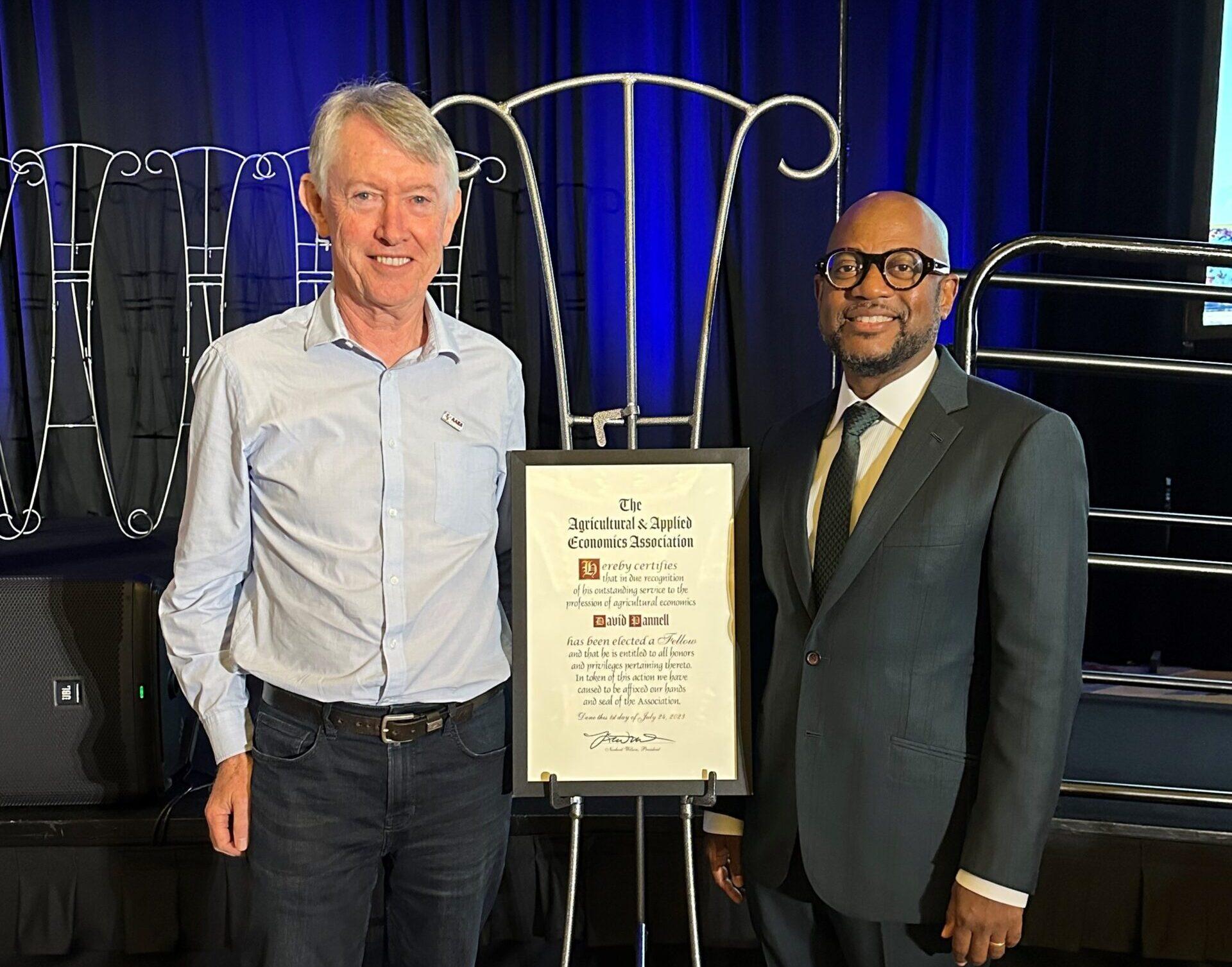 Pictured: Professor David Pannell (left) and Dr Norbert Wilson (right), president of the AAEA. Photo courtesy of the AAEA. 