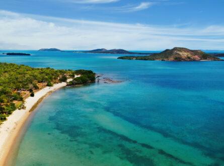 Aerial view of a sandy coastline and surrounding islands.