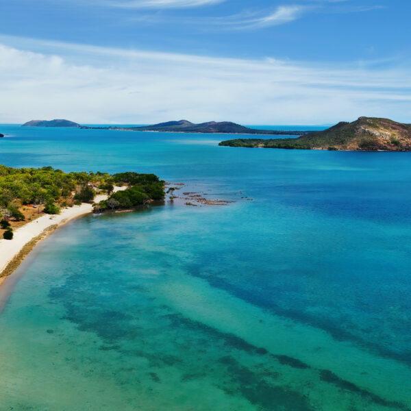 Aerial view of a sandy coastline and surrounding islands.