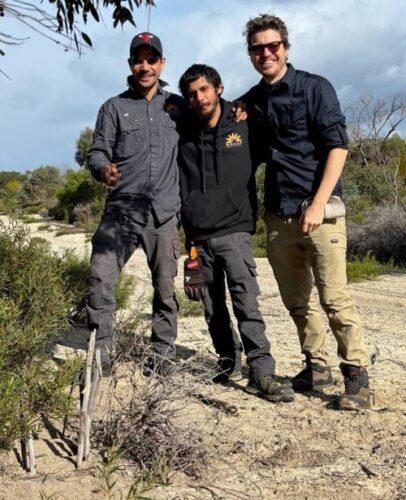 (L-R) Rangers from Binalup Aboriginal Corporation Ranger Program, Nicko Garlett and Jason Bolton , with NESP Resilient Landscapes Hub Researcher Luke Emerson from the University of Newcastle with a soft-jaw trap that has been set. Photo: Sarah Comer